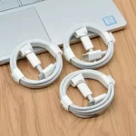 3 white type-c to type-c cables circle wrapped on a wooden table